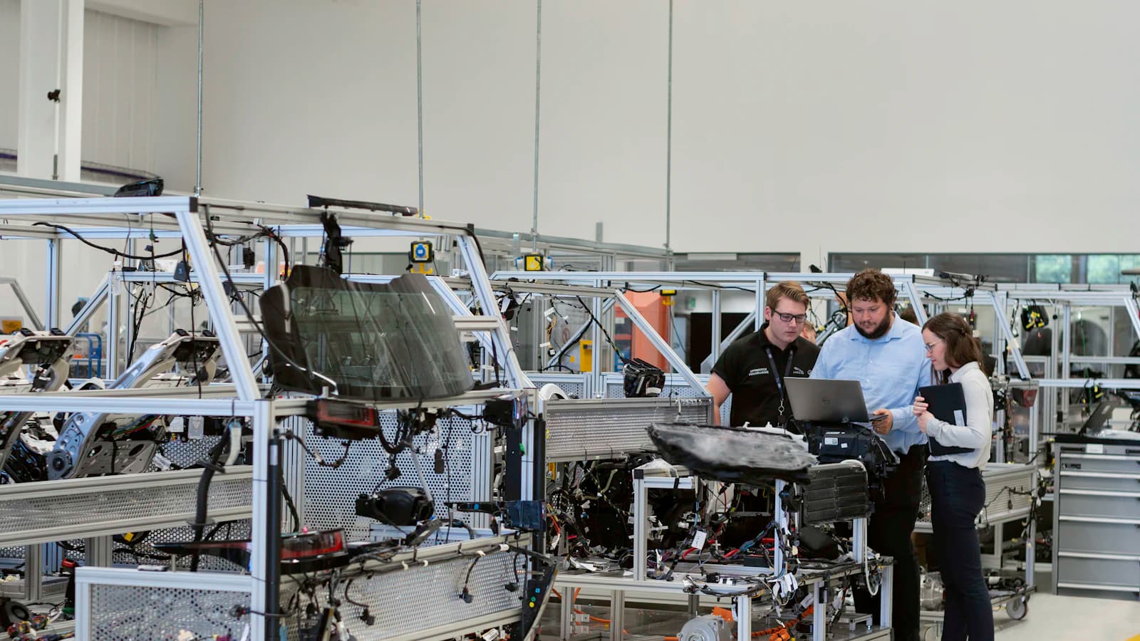 Engineers reviewing wiring assemblies together in a modern facility
