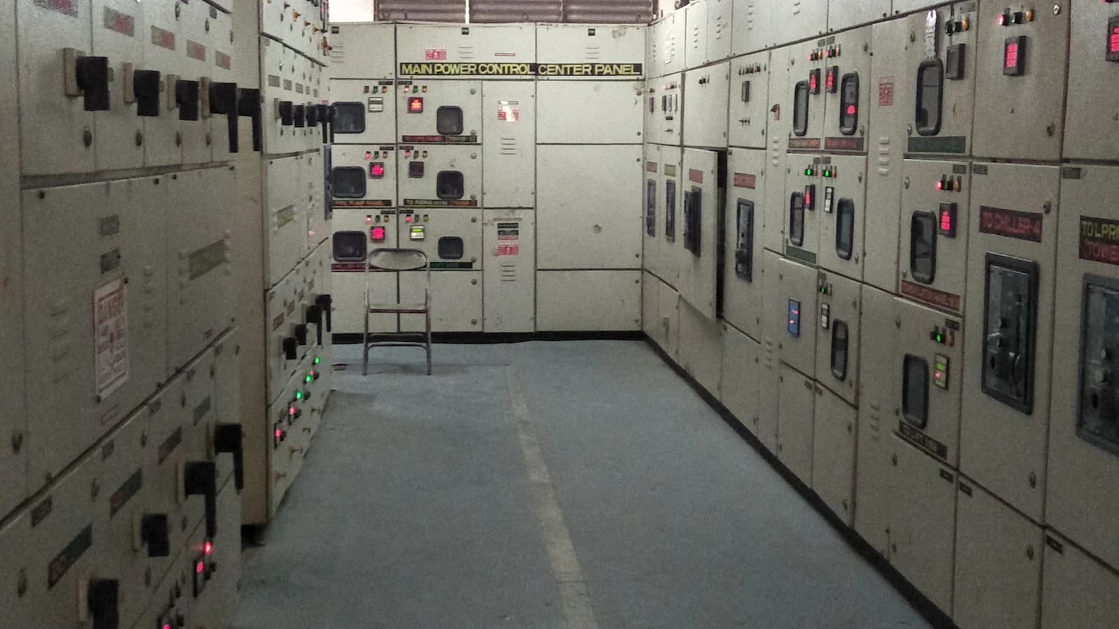 Rows of switchgear inside an industrial control panel room
